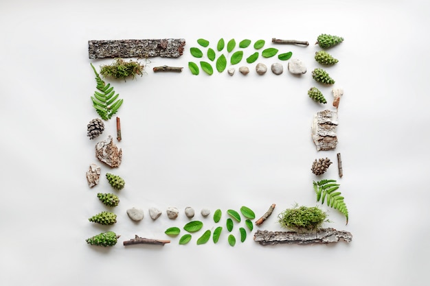 Square frame, natural layout of leaves, stones and wood