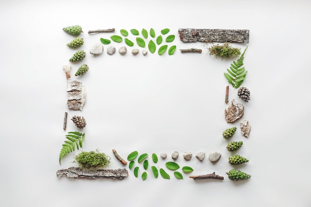 Square frame, natural layout of leaves, stones and wood