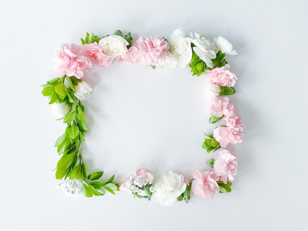 square frame of pink and white carnations leaves