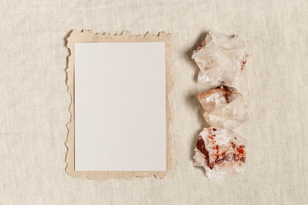 Square invitation card mock up blank greeting card and protection crystal healing stone quartz on table Torn paper Minimal business brand template Flat lay top view copy space