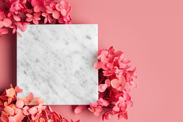 Square marble plate on pink background with flowers. Stylish background for presentation.