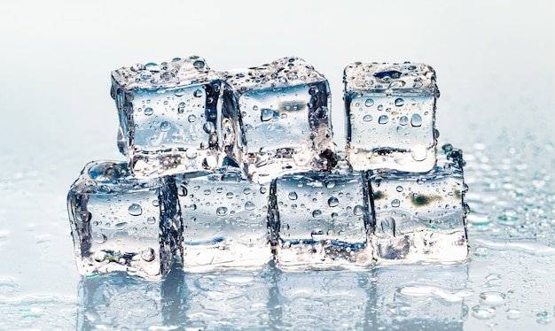 Square melting ice cubes on wet table