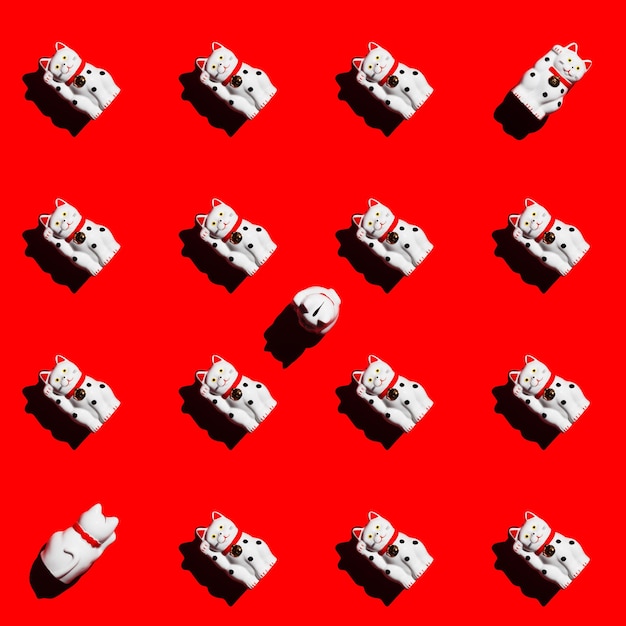 Square pattern of manekineko cats on a red background