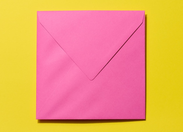 Square pink envelope on a yellow background