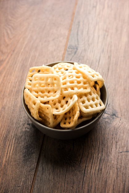 Square shape checkered Fryums Papad is a crunchy Snack Pellets served in a bowl