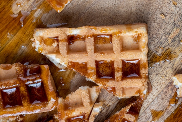 Square sweet soft waffles in bee honey