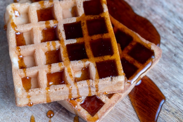 Square sweet soft waffles in bee honey