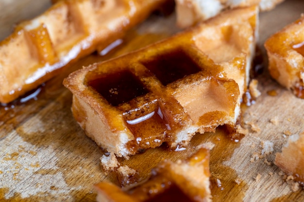 Square sweet soft waffles in bee honey