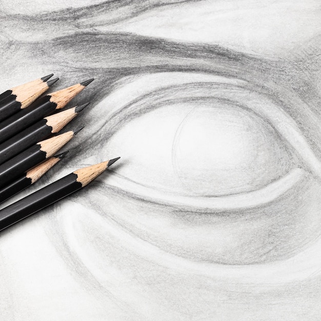 Square view of graphite pencils on drawing of eye