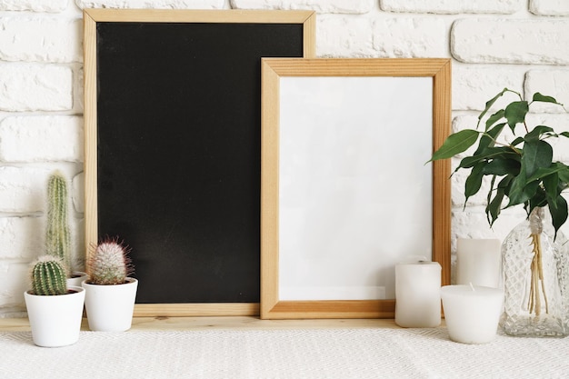 Square wooden photo frame and cactus plants on the table