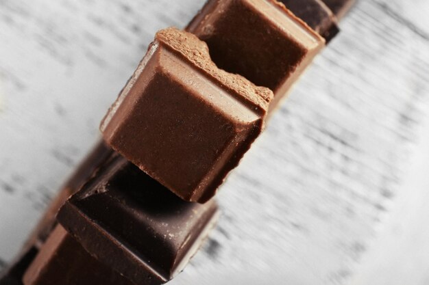 Squared chocolate on wooden table top view