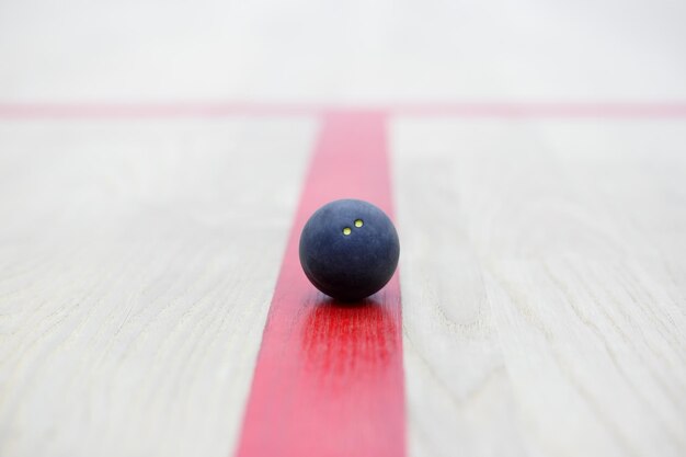 Photo squash ball on the wooden background