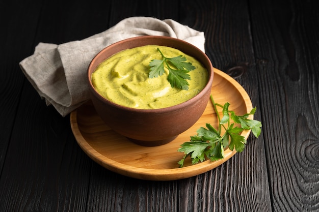 Squash caviar with parsley in a bowl on wooden