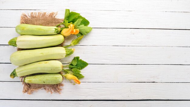 Squash Marrow zucchini Fresh vegetables On a white wooden table Top view Copy space