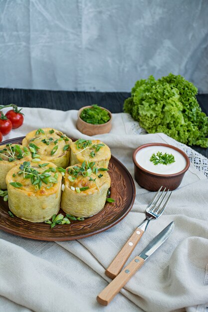 Squash stuffed with minced meat, vegetables and sprinkled with hard cheese. Side view.