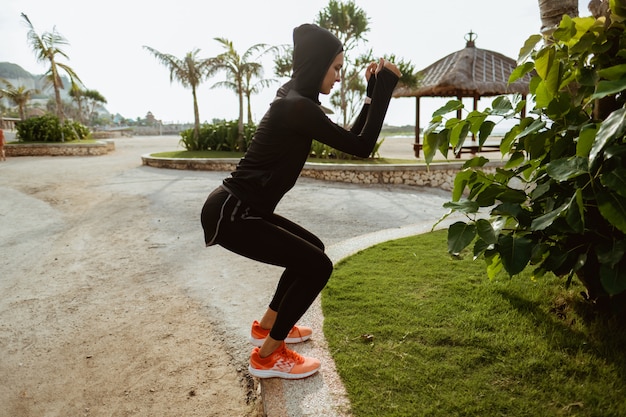 Squats, sport muslim woman squatting