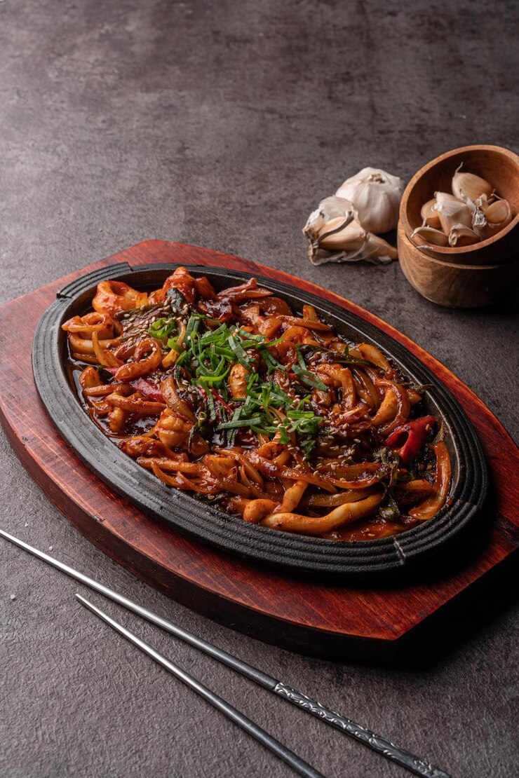 Squid cooked in a sweet and spicy sauce served in a hot plate
