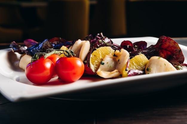 Squid with orange tomato and salad