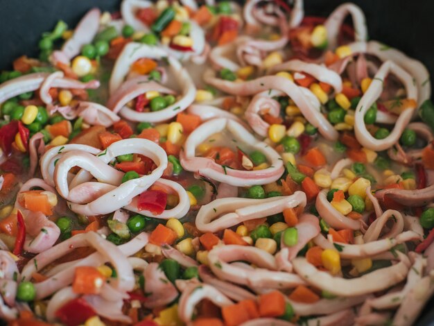 Squid with vegetables stewed in a pan