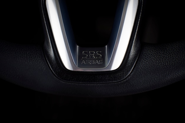 SRS Airbag icon on steering wheel in a luxury car.