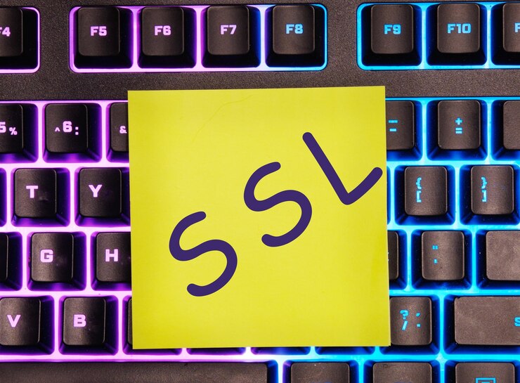 Photo ssl security certificate written on a yellow sticker on a laptop keyboard with backlight