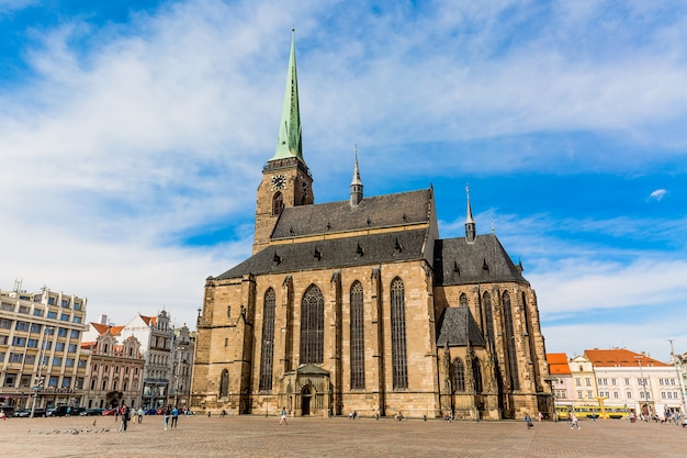 St. Bartholomew's Cathedral in the main square of Plzen with blue sky and clouds in sunny day. Czech Republic, Pilsen