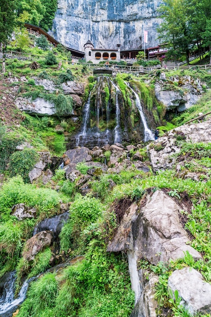 St. Beatus Cave and waterfalls above Thunersee, Sundlauenen, Switzerland.