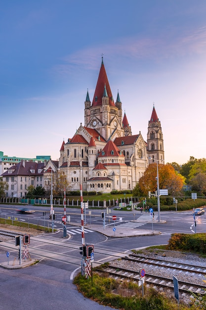 St. Francis of Assisi Church in Vienna sunset view with a railroad and car traffic