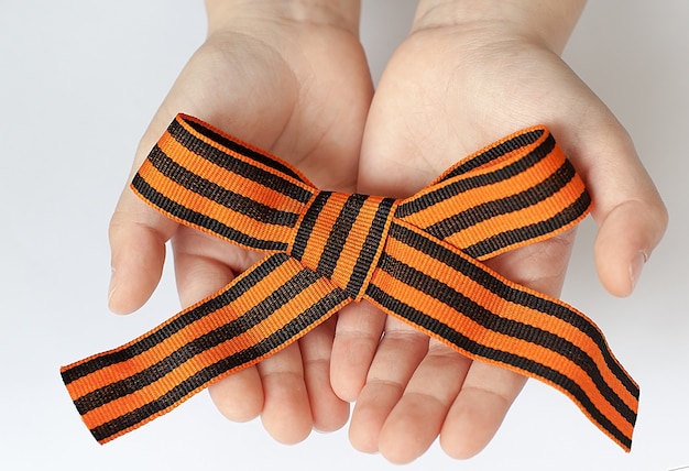 St. george's ribbon loop isolated on white background. black and orange ribbon.