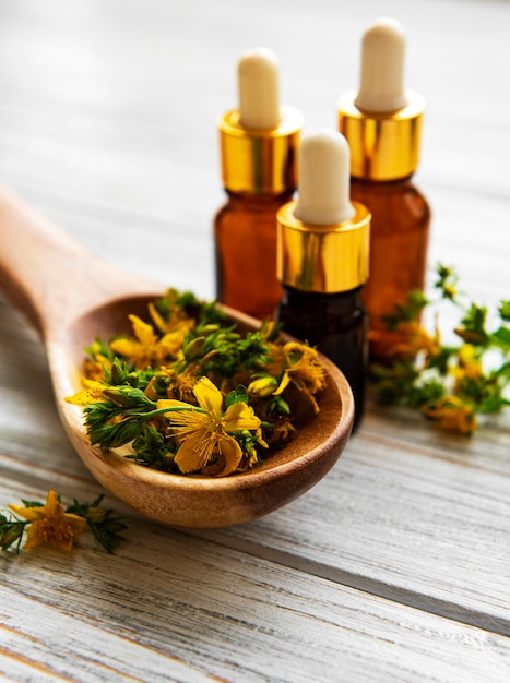 St John wort flowers with a bottle of natural oil