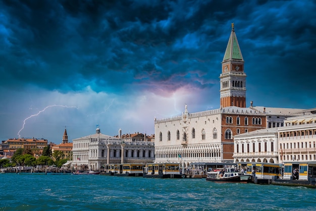 St Mark's Campanile tower in Venice, Italy. Beautiful tower at the St. Mark's Square during heavy storm and lightening..