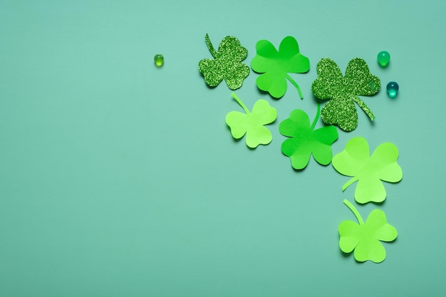 St Patrick's Day minimalistic concept Paper clover leaves on colored background with copy space