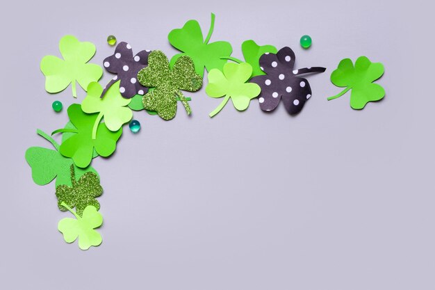 St Patrick's Day minimalistic concept Paper clover leaves on grey background with copy space