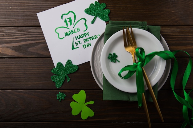 St Patrick's Day party table setting decorated with green leprechaun.