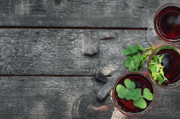 St Patricks Day Clover glass of wine on a wooden background