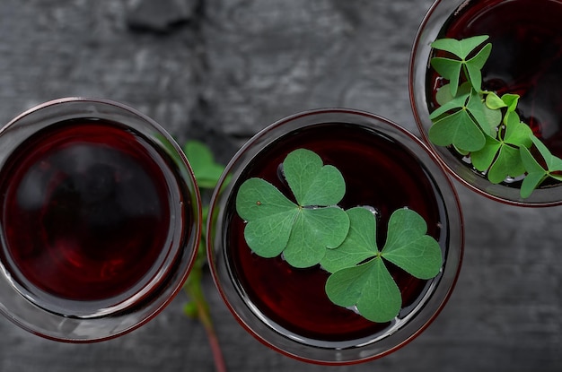 St Patricks Day Clover glass of wine on a wooden background