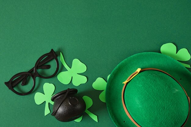 St patricks day flatley composition felt hat decorative clover and cauldron on green background