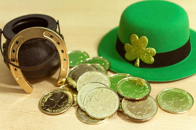 St Patricks day green hat and lucky pot full of golden coins fortune