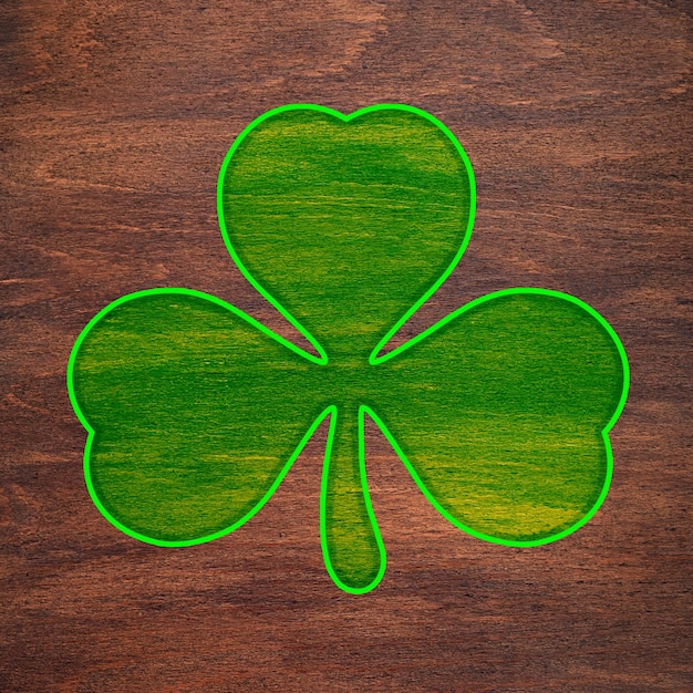 St Patricks Day Light green shamrock is painted on a wooden surface Three leaf clover