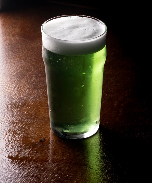 st patricks green beer pint over wooden table