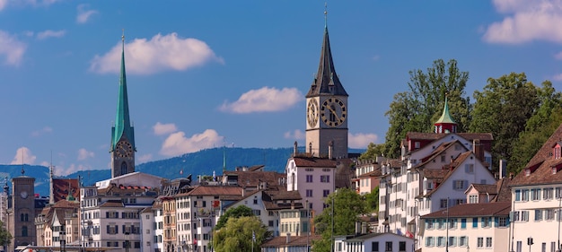 St peter church and famous fraumunster houses along limmat river in old town of zurich the largest c