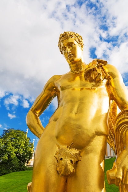 ST PETERSBURG, RUSSIA - SEPTEMBER 08, 2014: Peterhof Palace golden statue of a man. The Peterhof Palace included in the UNESCO's World Heritage List.