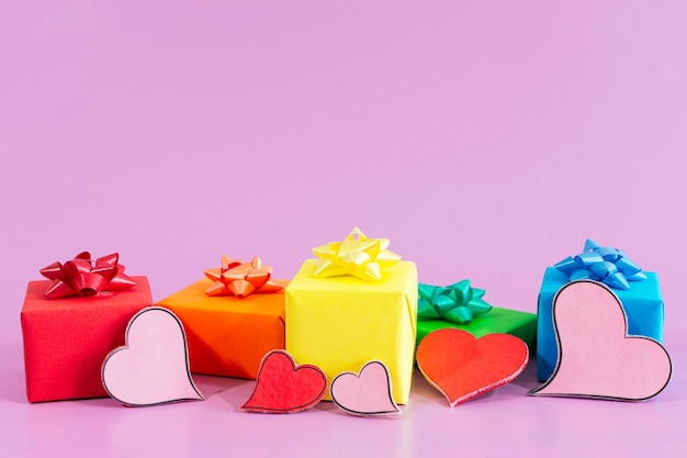 St Valentine Day, LGBTQ color gifts on pink background.