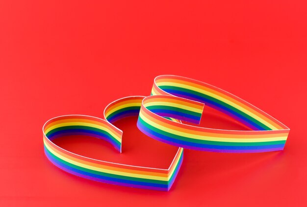 Photo st. valentine day.two hearts, paint of a six-colour gay flag.