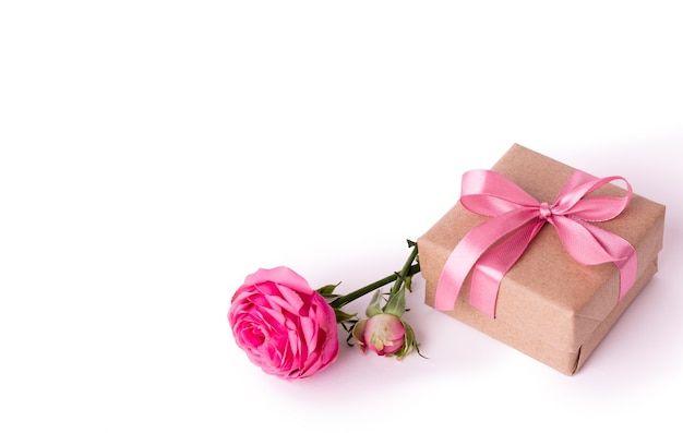 St. Valentines Day concept. Pink rose and gift box with ribbon isolated on white.