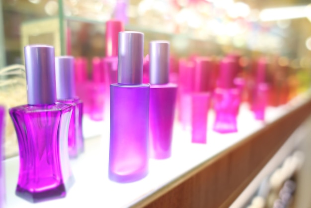 Staan met kleurrijke glazen flessen in cosmetische winkel