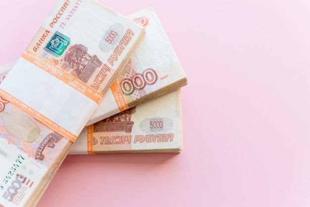 Stack of 5000 rubles packs isolated on pink background