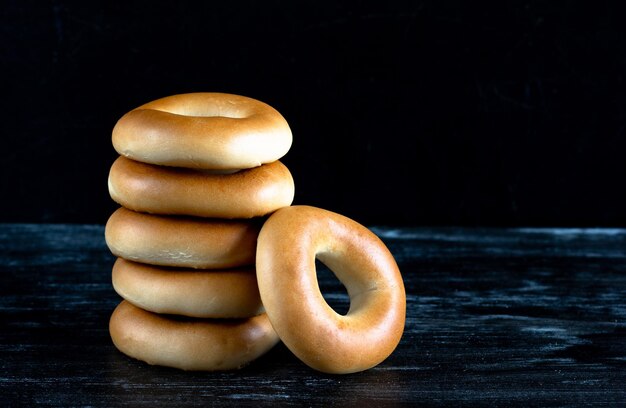 Stack of bagels on the black background