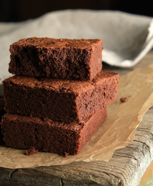 Stack of baked square pieces of chocolate brownie cake