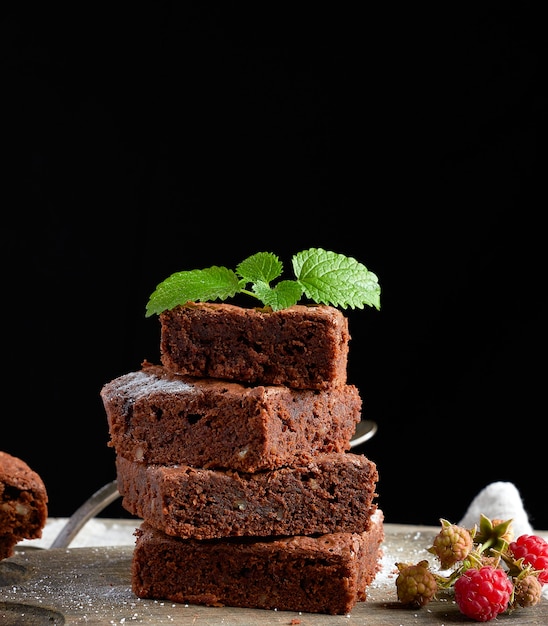 Stack of baked square pieces of chocolate brownie cake